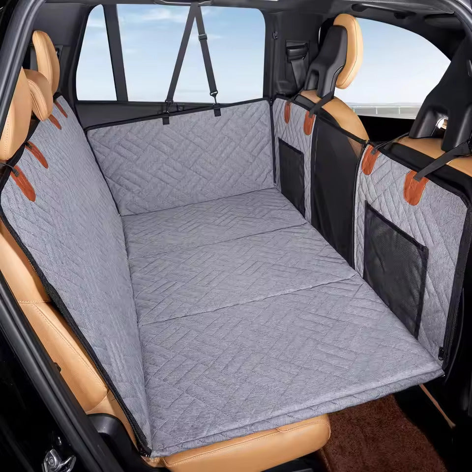 Car interior with a gray quilted bench seat cover and brown accents.
